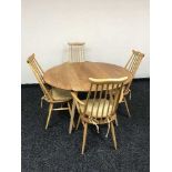 An Ercol elm drop leaf kitchen table and four chairs