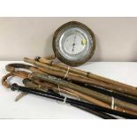 A bundle of walking sticks and umbrellas plus an oak cased barometer