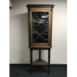 A Victorian oak glazed door corner cabinet on stand