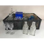 A basket of glass, decanters, drinking glasses,