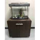 A Fish Box fish tank with accessories on double door stand