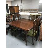 A late Victorian mahogany wind out dining table and a set of Victorian inlaid mahogany dining