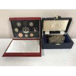 A boxed silver comb and hand brush with a boxed Royal Mint 1993 proof coin set
