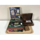 A tray of two boxed Texas Holdem poker sets, games compendium, brass box of dominoes and dice,