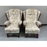 A pair of wing back armchairs