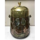 An Art Nouveau brass and copper lidded log bucket
