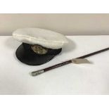 A military swagger stick and a Naval cap with badge