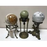 Three early 20th century metal stands surmounted by spherical marble balls