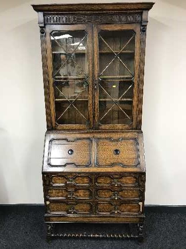 An Edwardian carved oak bureau bookcase