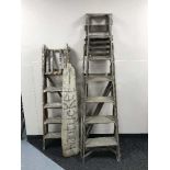 Two sets of folding wooden step ladders and a piece of driftwood