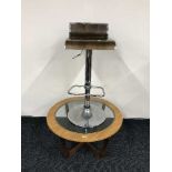 A teak coffee table and a chrome bar chair