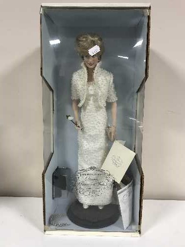 A boxed Franklin Mint Diana Princess of Wales porcelain doll and four Marilyn Monroe dolls