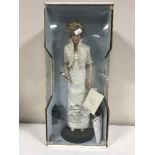 A boxed Franklin Mint Diana Princess of Wales porcelain doll and four Marilyn Monroe dolls