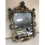 A decorative framed rococo style mirror