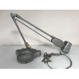 A mid 20th century industrial angle poise lamp with magnifying glass