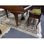 A fringed Keshan Persian carpet 230 cm x 160 cm on green ground