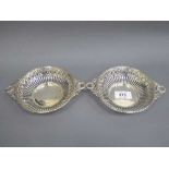 A pair of silver bon bon dishes with pierced sides and floral swag handles, 197.8g.