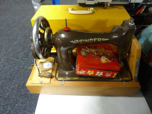 A Singer hand sewing machine in case