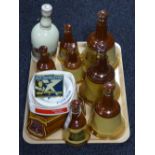 A tray of a quantity of Wade, Bells and Famous Grouse whisky decanters, some filled,