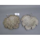 A pair of continental white metal leaf dishes with engraved decoration, 438.3g.