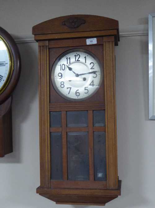 An oak cased wall clock, two framed pictures, continental figure,