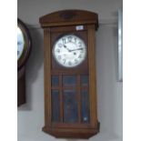 An oak cased wall clock, two framed pictures, continental figure,