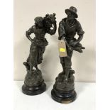 A pair of spelter figures on wooden bases depicting wheat gatherers