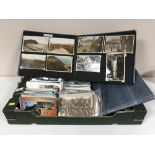 A box of assorted post cards and two post card albums