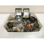 A box of a large quantity of military badges and buttons, some silver,