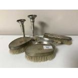 A pair of silver backed dressing table brushes together with a small silver dish and a further