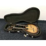 An Antonio Tsai double neck mandolin with mother of pearl inlay in a hard carry case