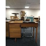 A singer sewing machine in teak table