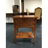 An inlaid yew wood three-drawer side table