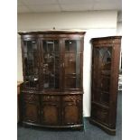 A mahogany Bradley triple door display cabinet fitted cupboards beneath together with matching