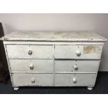 An antique painted pine six drawer chest