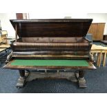 A rosewood baby grand piano converted into a writing desk