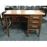 A mid 20th century oak flap sided desk fitted three drawers