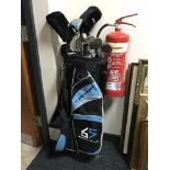 A Dunlop golf bag containing a part set of Dunlop golf clubs