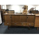 A mid 20th century teak concertina door sideboard