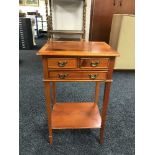 An inlaid yew wood three-drawer side table