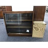 A mahogany sliding glass door bookcase together with a loom glass topped linen box