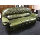 A green leather three seater settee