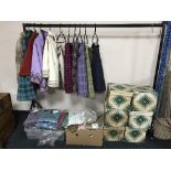 A quantity of vintage lady's cloths including woollen skirts with capes, woollen skirts, hats,