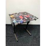 A mid-20th century school desk (80's rock bands)