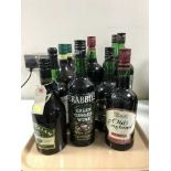 A tray containing twelve bottles of alcohol including Irish and English Cream, ginger wine,