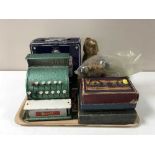 A tray containing a mid-20th century Merit tin plate cash register,