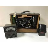 A cased Singer sewing machine together with a Bakelite cased avometer,