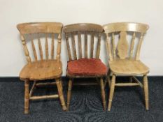 Three odd pine kitchen chairs