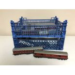 A collection of early tin plate railway carriages and a crate of assorted rolling stock