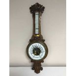 A carved oak cased banjo barometer